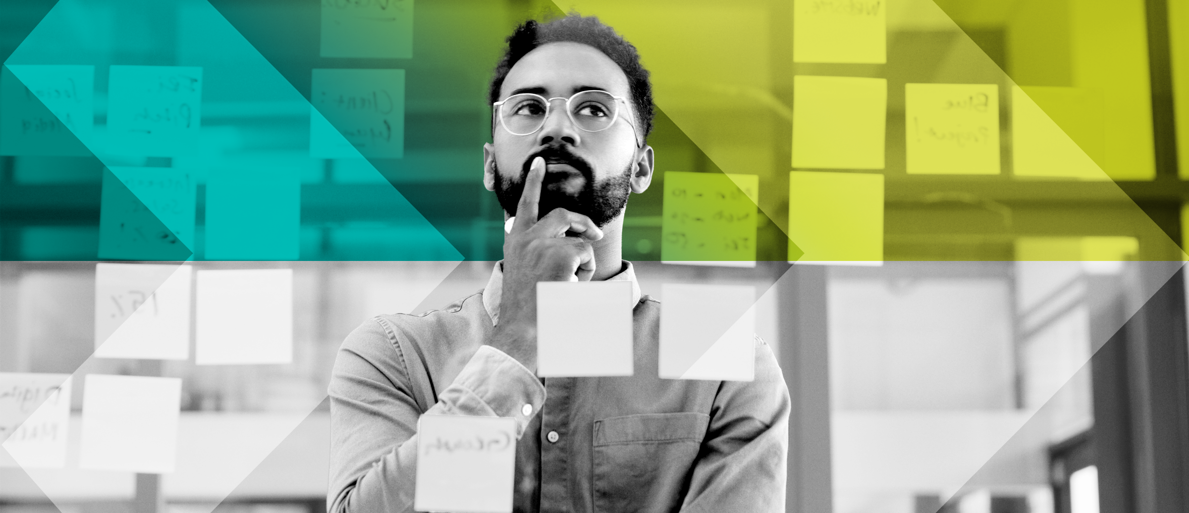 A person looking at a glass wall with sticky notes