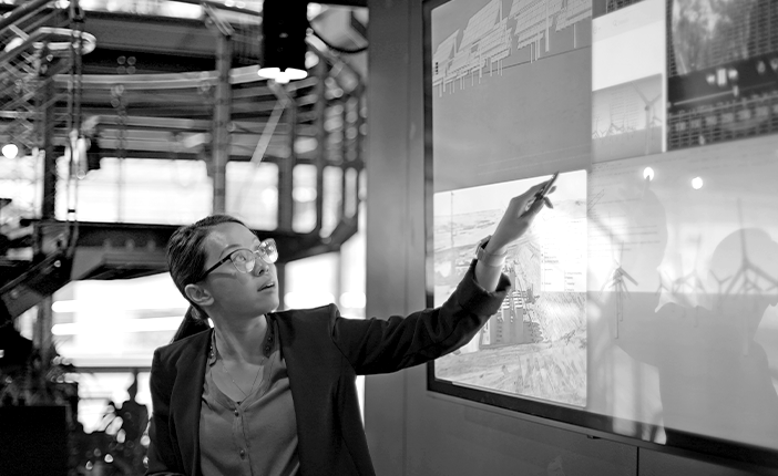 A person pointing at a screen