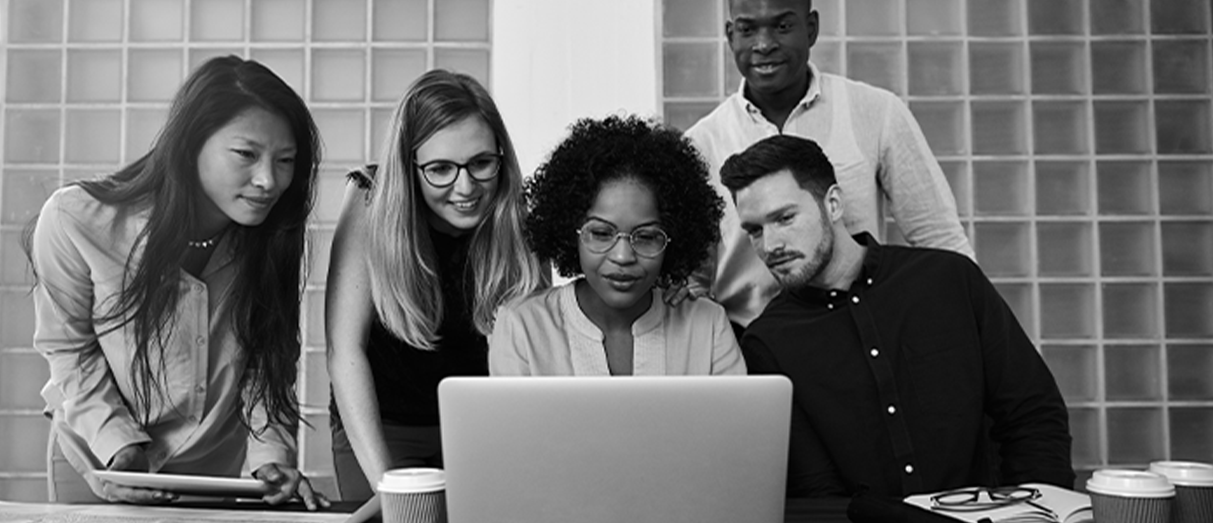 A group of people looking at a computer