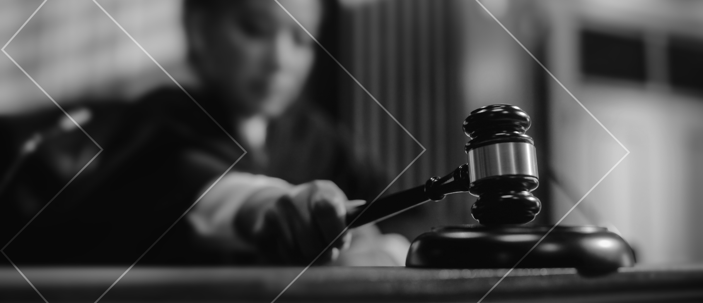 A close-up of a person's hand with a gavel