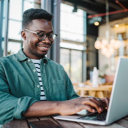 A man sitting at a table using a computer