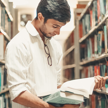 A man holding a book in a library