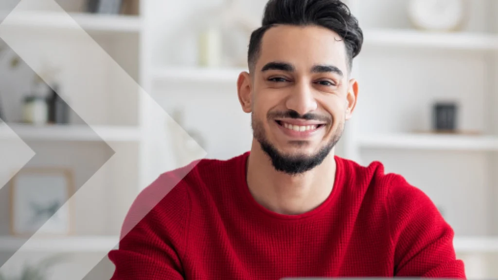 A young man smiling at the camera.