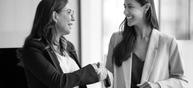 Two women shaking hands. 