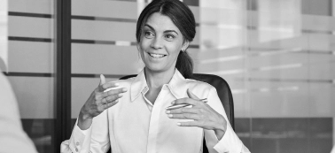 A woman speaking in a work meeting.