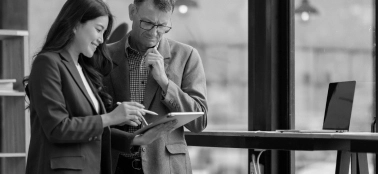 A man and a woman reviewing a document. 