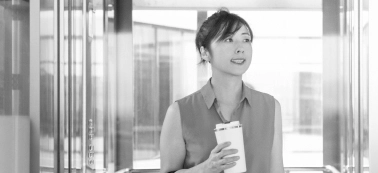A woman in an office with coffee mug.