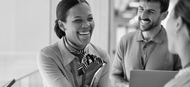 People smiling in a work meeting.