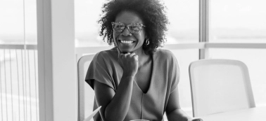 A woman smiles at camera.
