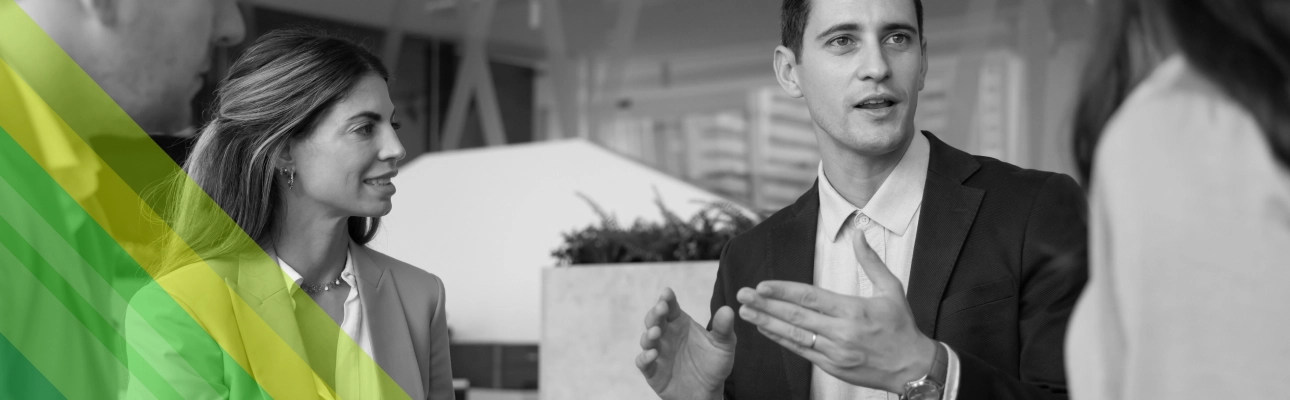 A man explaining something in a work meeting.