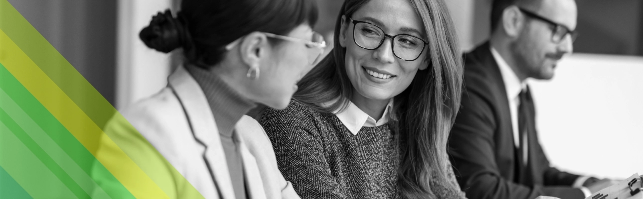 Two women smiling at each other.