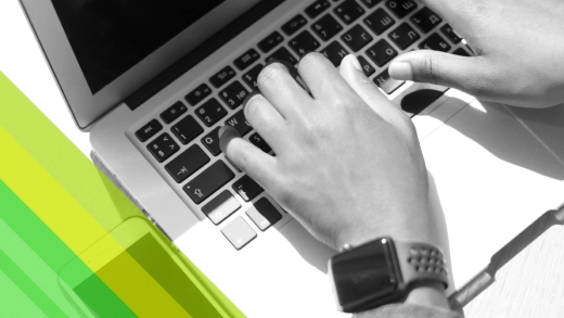 Hands and a laptop in the frame.