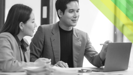 A man and a woman looking at a laptop.