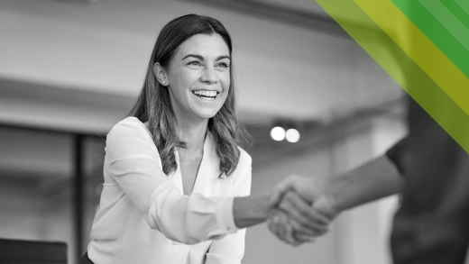 A woman shaking hands with a man.