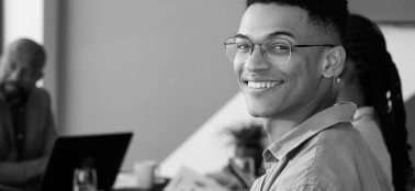 A man smiling to the camera.